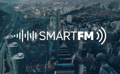 SmartFM logo over Santiago town view